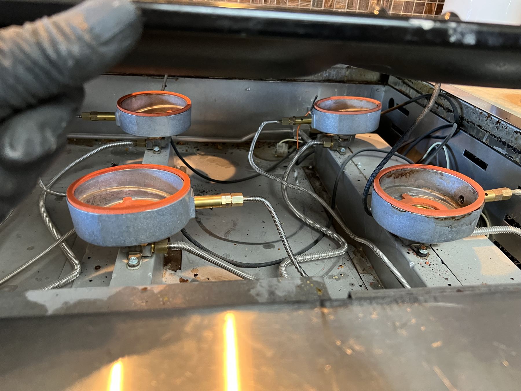 Wolf rangetop opened up for burner service