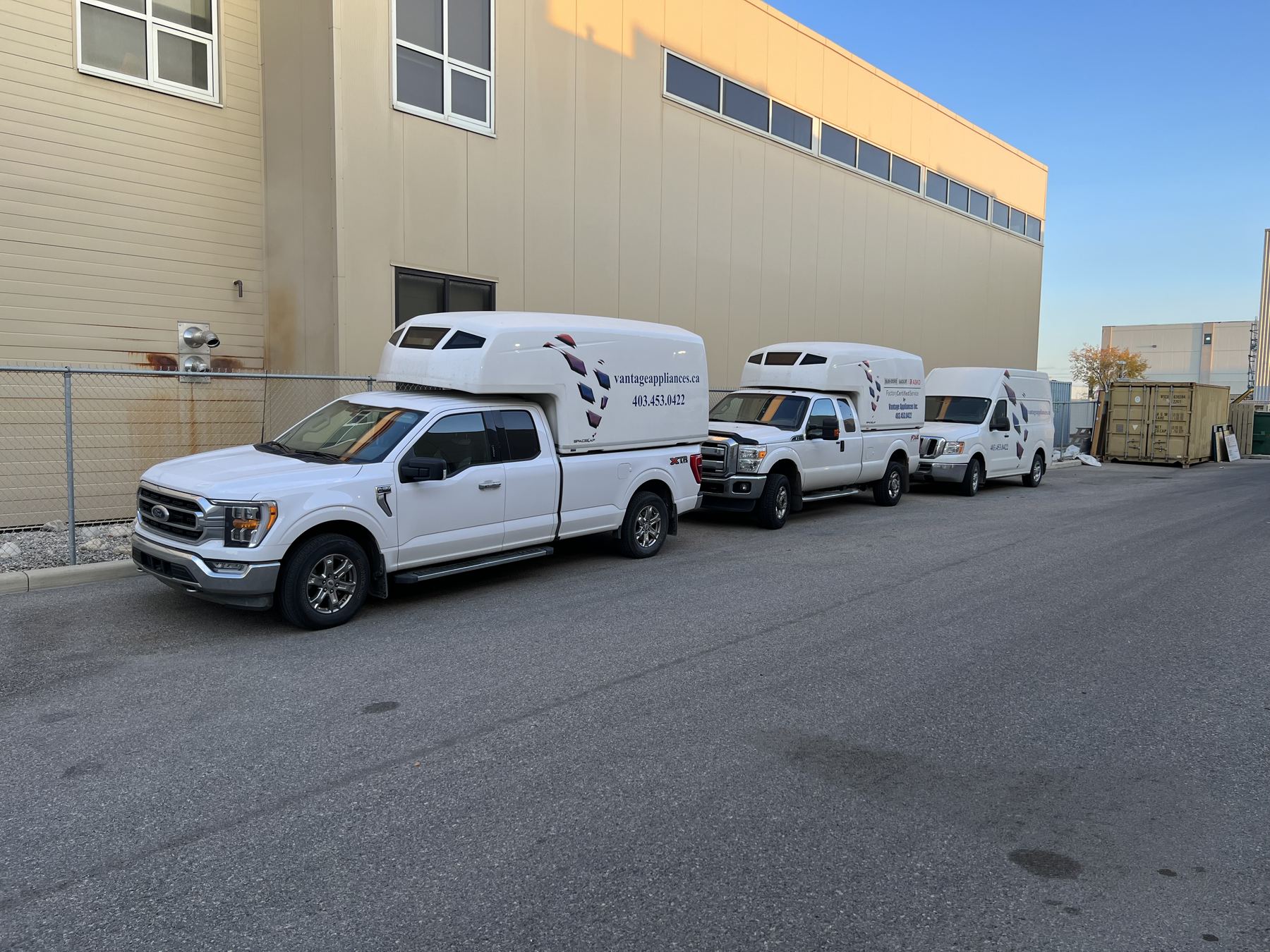 Three Vantage service trucks parked in a row outside the service centre